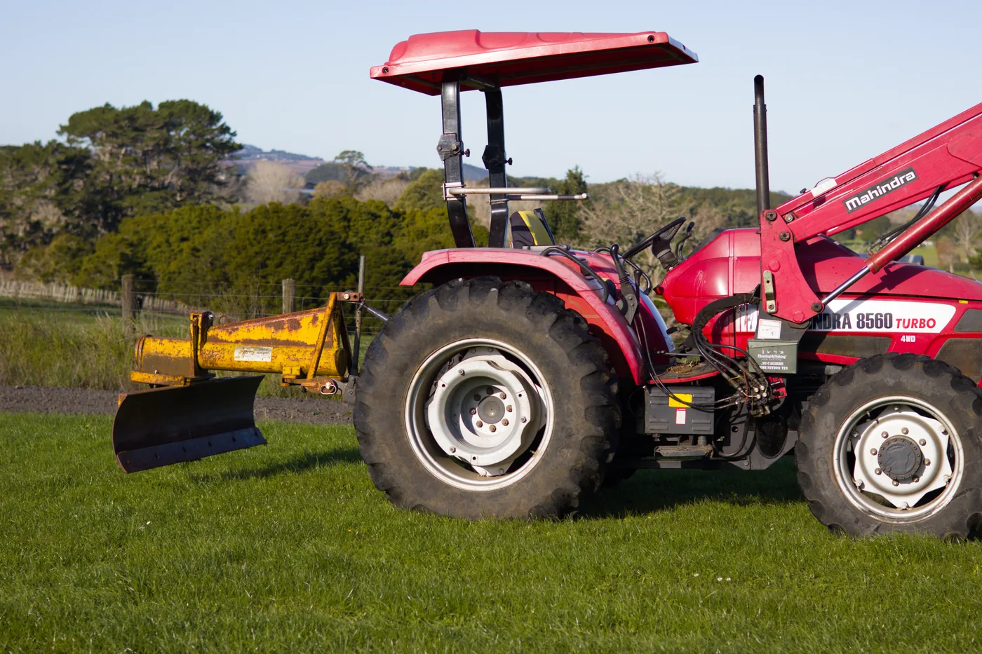 Tractor with grader blade